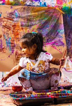 Children experimenting with vibrant paint techniques at Artnest Studio