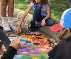 Teacher guiding kids through creative art project